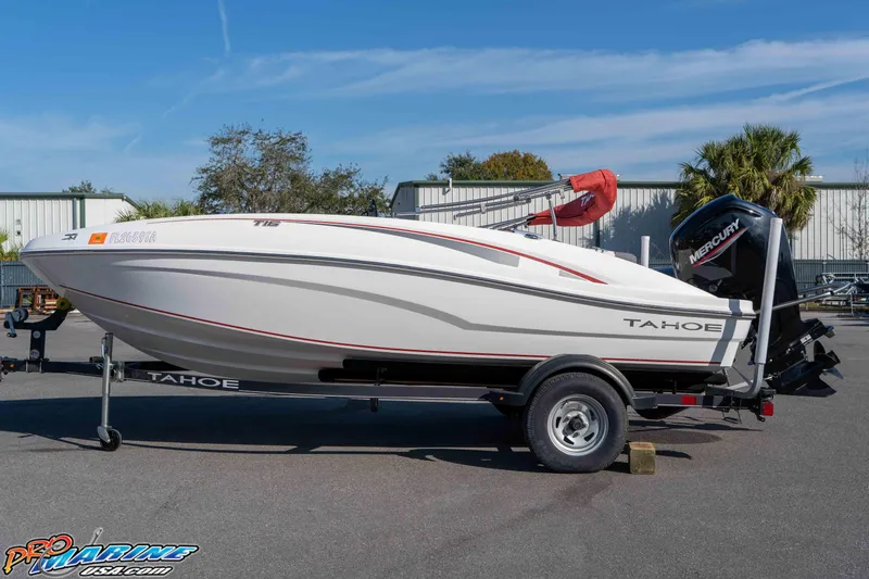 Slide: The Image of 2021 Tahoe T16 boat on trailer with Mercury engine, parked outdoors. - 10