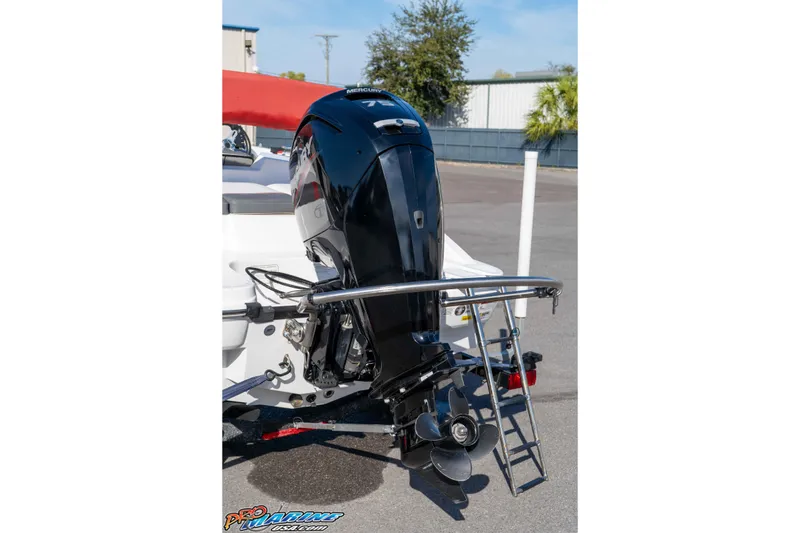 Slide: The Image of 2021 Tahoe T16 boat with Mercury outboard motor and swim ladder, parked outdoors. - 11
