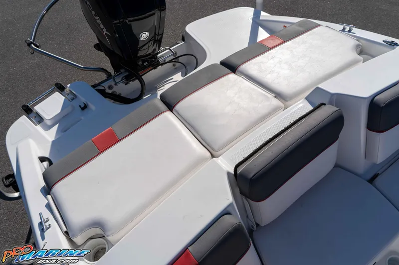 Slide: The Image of 2021 Tahoe T16 boat seating area with white and gray cushions, featuring red accents. - 14