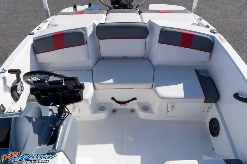 Slide: The Image of 2021 Tahoe T16 boat interior with seating and steering wheel, featuring red and gray accents. - 16