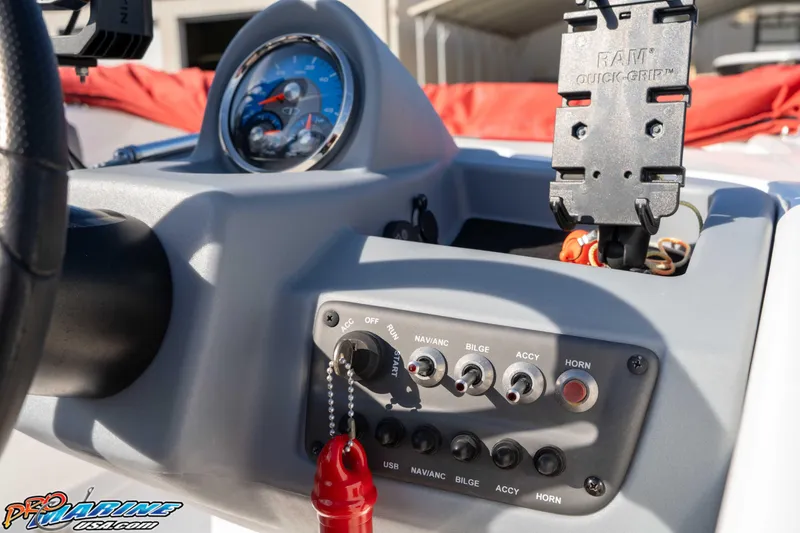Slide: The Image of Dashboard of a 2021 Tahoe T16 boat with control switches and gauge. - 18