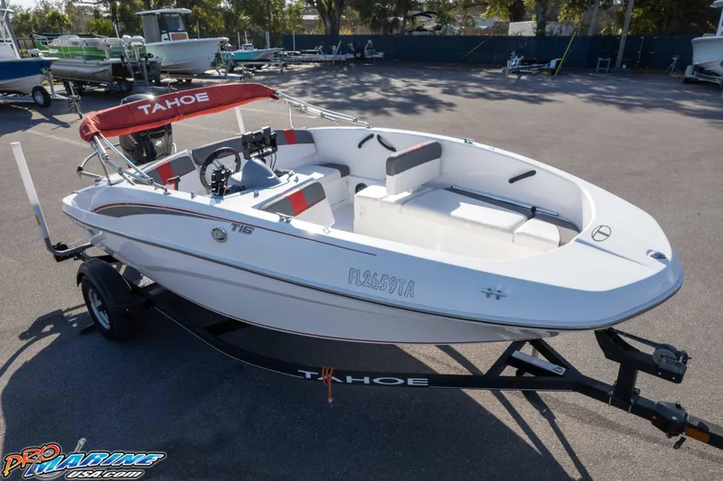 Slide: The Image of 2021 Tahoe T16 boat on trailer in parking lot, featuring red canopy and sleek design. - 21