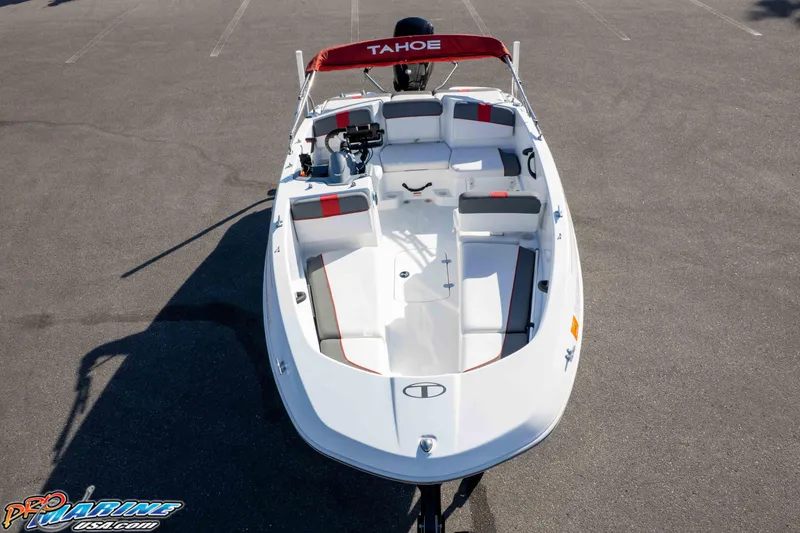 Slide: The Image of 2021 Tahoe T16 boat with red canopy, white interior, and gray accents, parked on asphalt. - 25