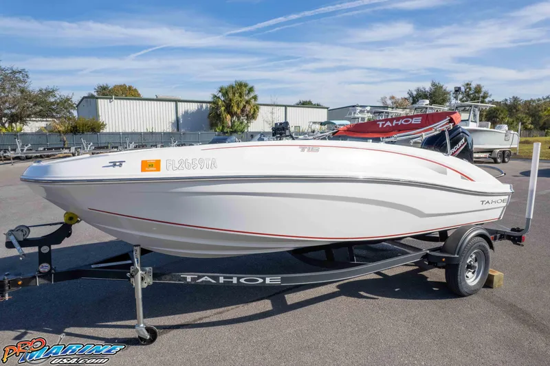 Slide: The Image of 2021 Tahoe T16 boat on trailer, parked outdoors under clear sky. - 26