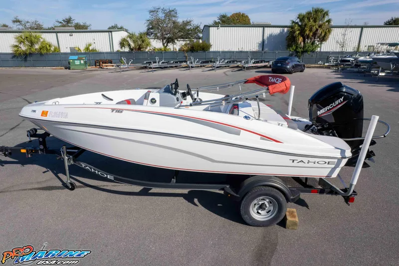 Slide: The Image of 2021 Tahoe T16 boat on trailer with Mercury engine, parked outdoors. - 30