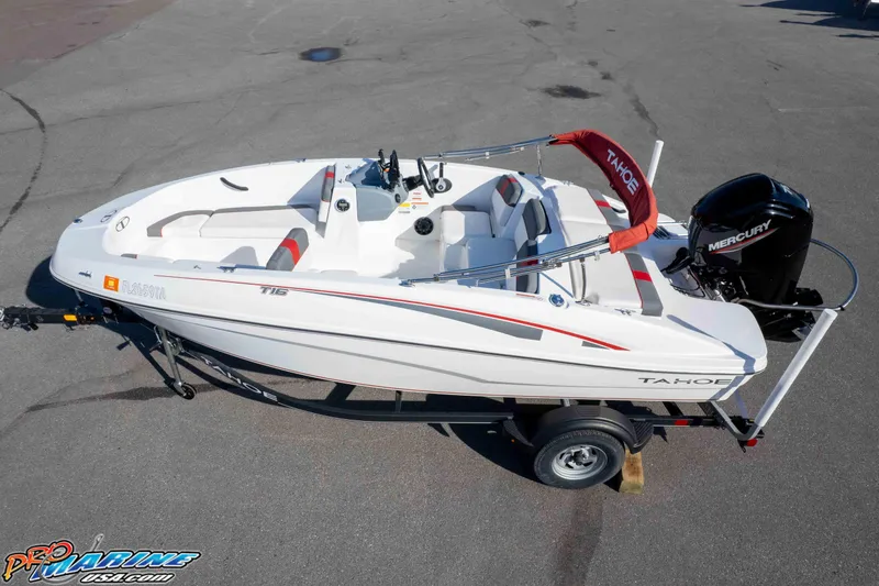 Slide: The Image of 2021 Tahoe T16 boat on trailer with Mercury engine, white and red design. - 31