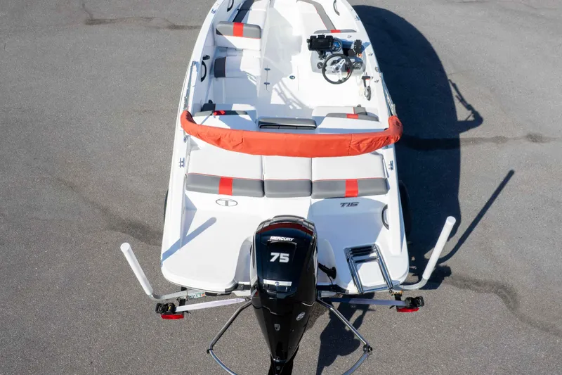 Slide: The Image of 2021 Tahoe T16 boat with Mercury 75 engine, top view, parked on pavement. - 34