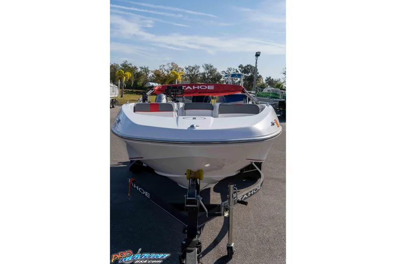 Slide: The Image of 2021 Tahoe T16 boat on trailer, parked outdoors under clear sky. - 6