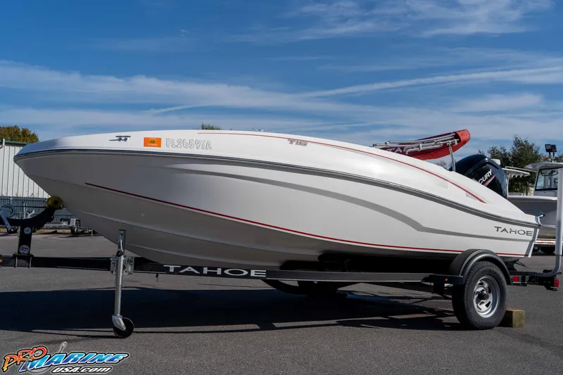 Slide: The Image of 2021 Tahoe T16 boat on trailer under clear blue sky. - 7