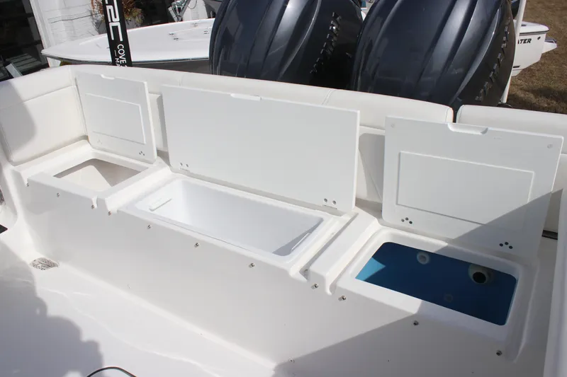 Slide: The Image of 2026 Tidewater 256 LXF boat with open storage compartments and dual engines. - 14