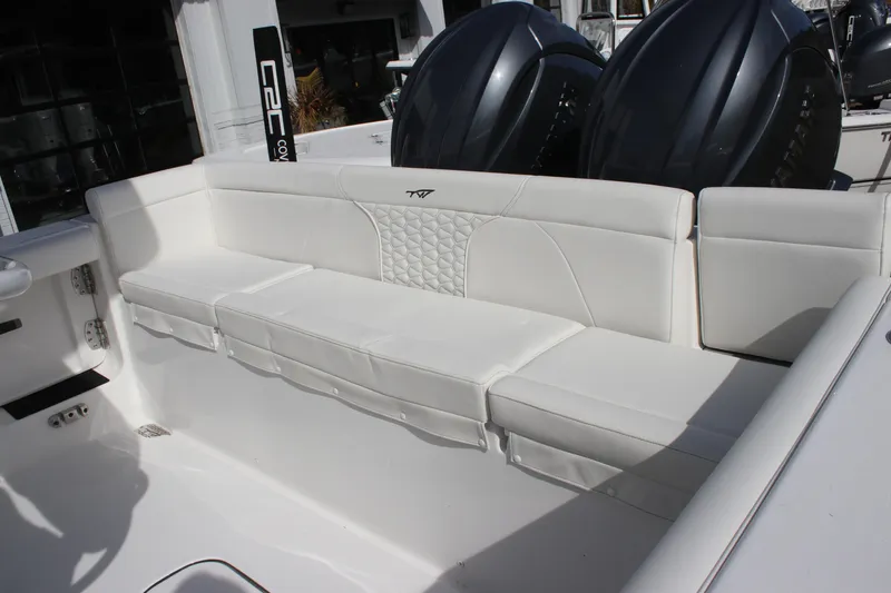 Slide: The Image of 2026 Tidewater 256 LXF boat with luxurious white seating and dual engines. - 15