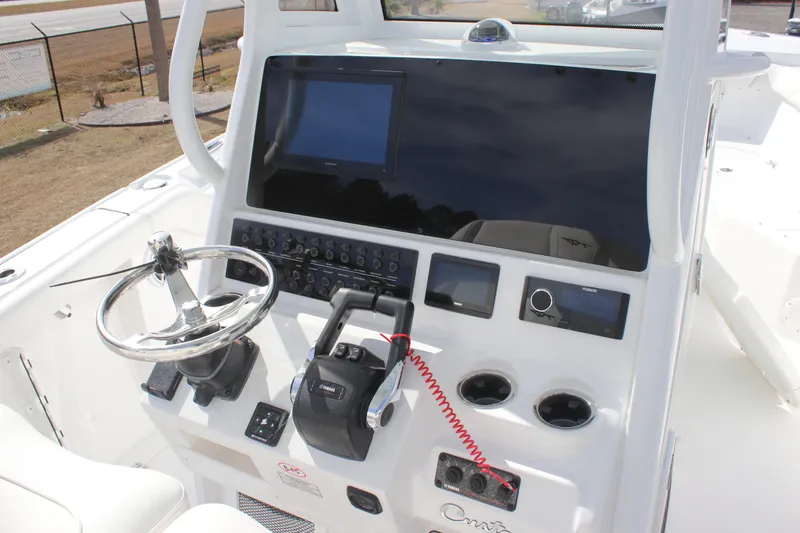 Slide: The Image of 2026 Tidewater 256 LXF boat dashboard with steering wheel and control panel. - 17