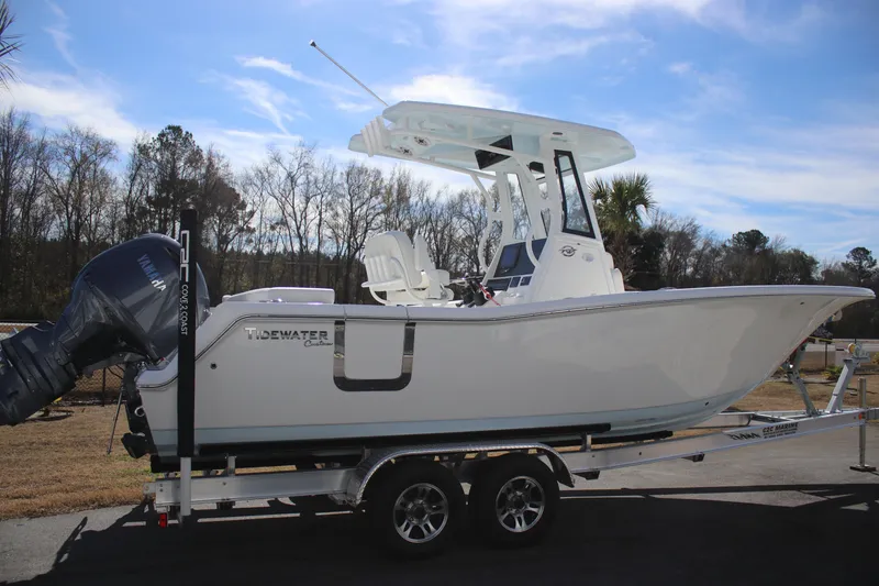 Slide: The Image of 2026 Tidewater 256 LXF boat on trailer, side view, outdoors. - 2