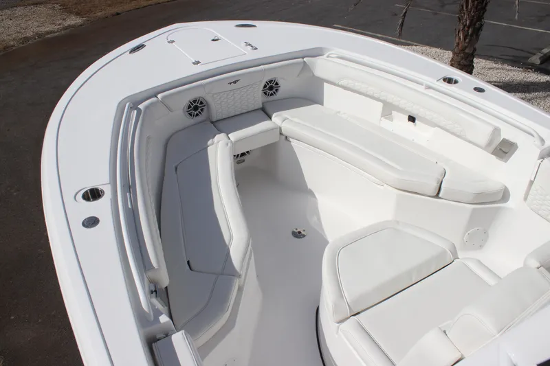 Slide: The Image of 2026 Tidewater 256 LXF boat interior with white seating and speakers. - 21
