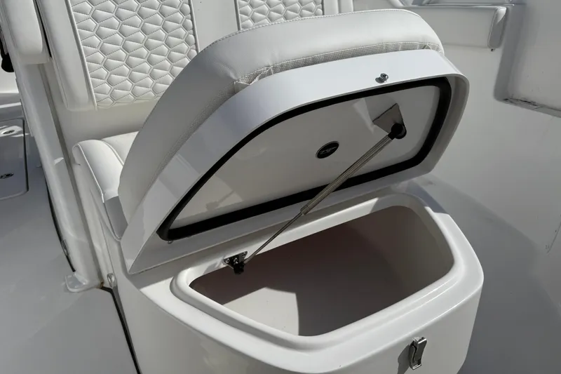 Slide: The Image of Open storage compartment on 2026 Tidewater 256 LXF boat with cushioned seating. - 22