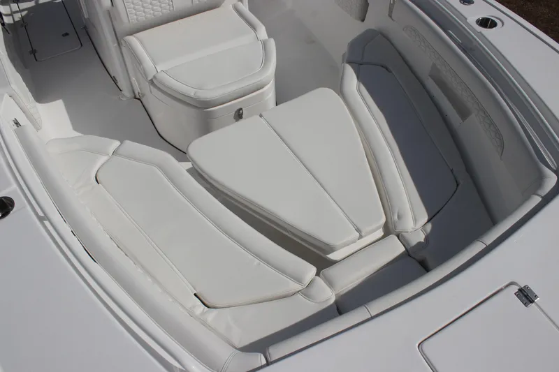 Slide: The Image of 2026 Tidewater 256 LXF boat interior with white cushioned seating arrangement. - 23