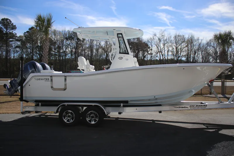 Slide: The Image of 2026 Tidewater 256 LXF boat on trailer, parked outdoors under clear sky. - 3