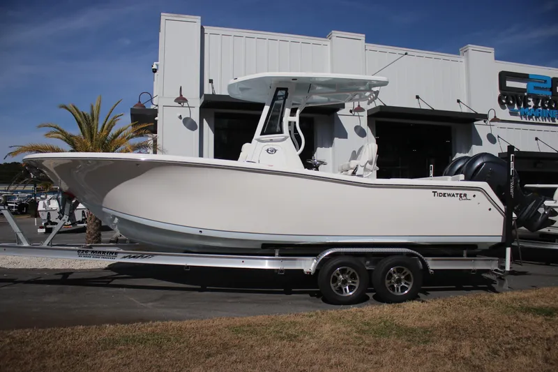 Slide: The Image of 2026 Tidewater 256 LXF boat on trailer outside marine dealership. - 4