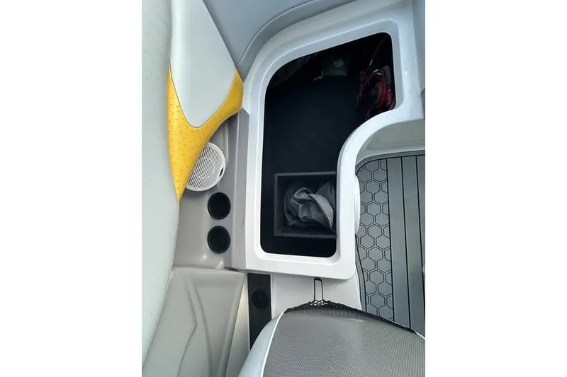 Slide: The Image of 2004 MasterCraft XStar 23 interior storage compartment with yellow and gray accents. - 10