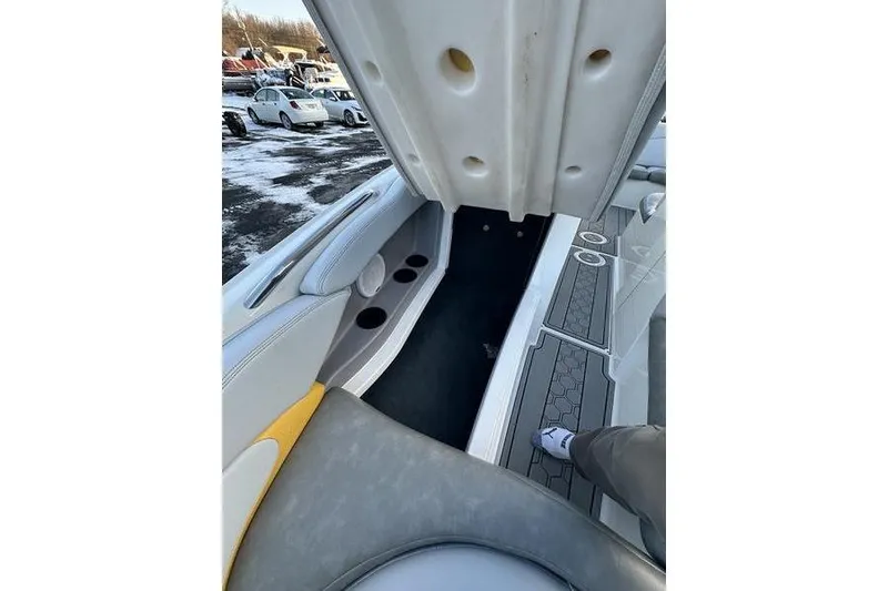 Slide: The Image of 2004 MasterCraft XStar 23 interior with seating and storage compartments. - 11