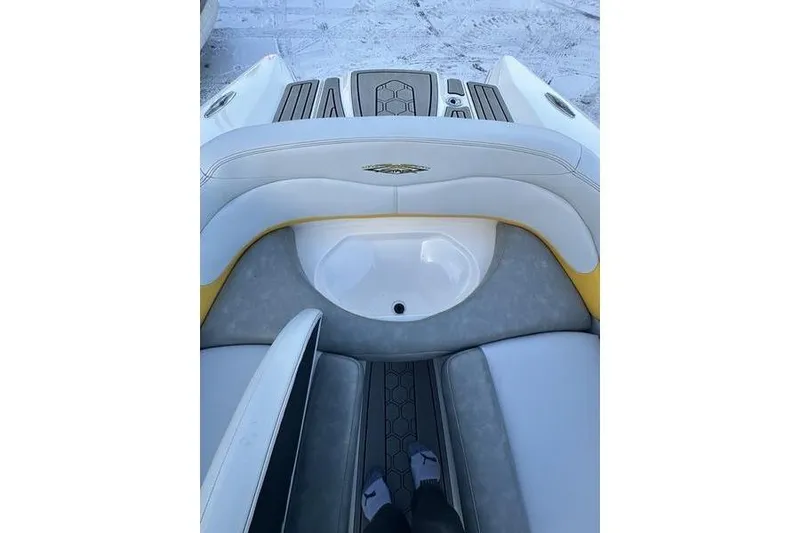 Slide: The Image of 2004 MasterCraft XStar 23 boat interior with white and yellow seating. - 12