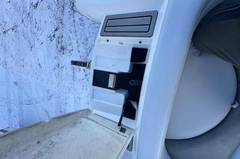 Slide: The Image of 2004 MasterCraft XStar 23 boat interior detail with storage compartment and snowy background. - 14