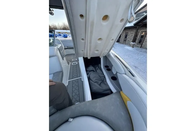 Slide: The Image of 2004 MasterCraft XStar 23 interior with open storage compartment and seating. - 17