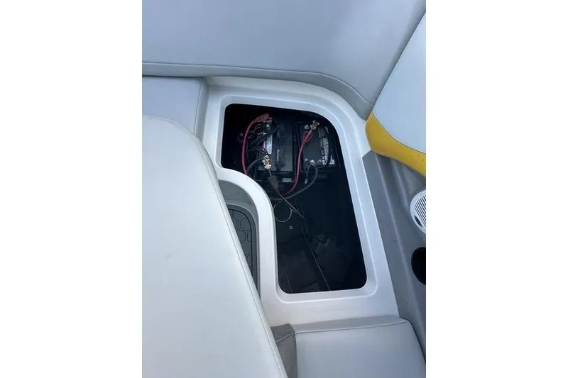 Slide: The Image of 2004 MasterCraft XStar 23 boat battery compartment with wiring and seating area. - 4