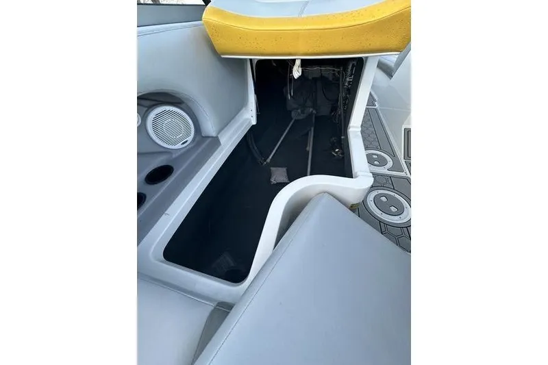 Slide: The Image of 2004 MasterCraft XStar 23 interior storage compartment with speaker and cup holders. - 5