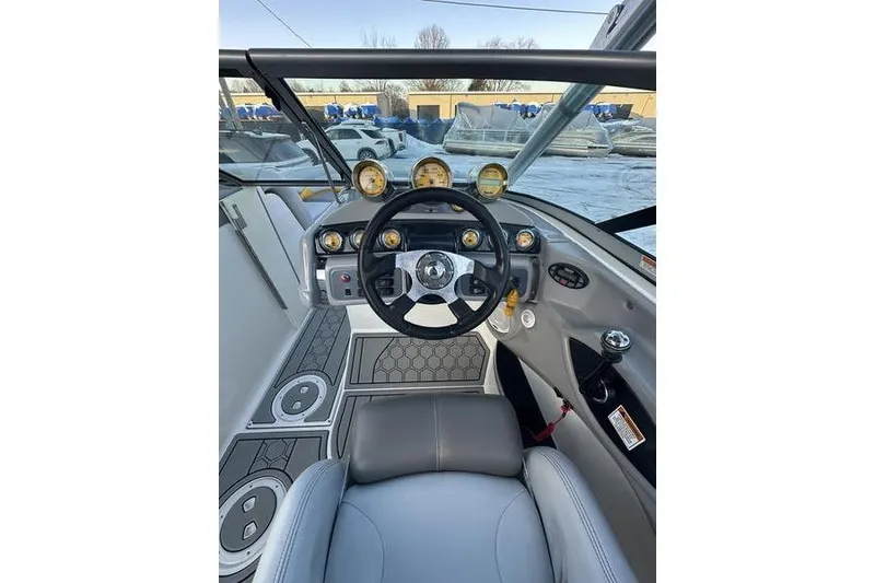Slide: The Image of 2004 MasterCraft XStar 23 boat cockpit with steering wheel and gauges. - 9