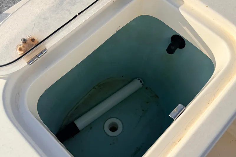 Slide: The Image of Open storage compartment on 2020 Cobia 220 Center Console boat. - 11