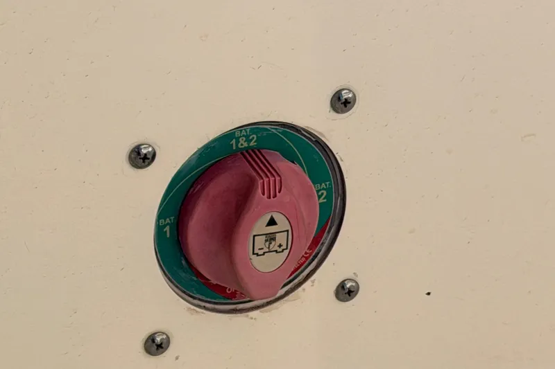 Slide: The Image of Battery switch on 2020 Cobia 220 Center Console boat, showing settings for BAT 1, 2, and 1&2. - 13