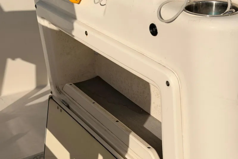 Slide: The Image of 2020 Cobia 220 Center Console boat storage compartment detail. - 19
