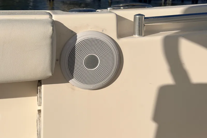Slide: The Image of Speaker on a 2020 Cobia 220 Center Console boat, featuring a white cushioned seat. - 23