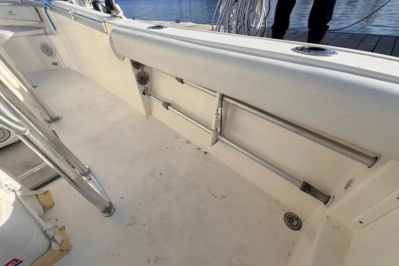 Slide: The Image of 2020 Cobia 220 Center Console boat interior with rod holders and clean deck. - 26