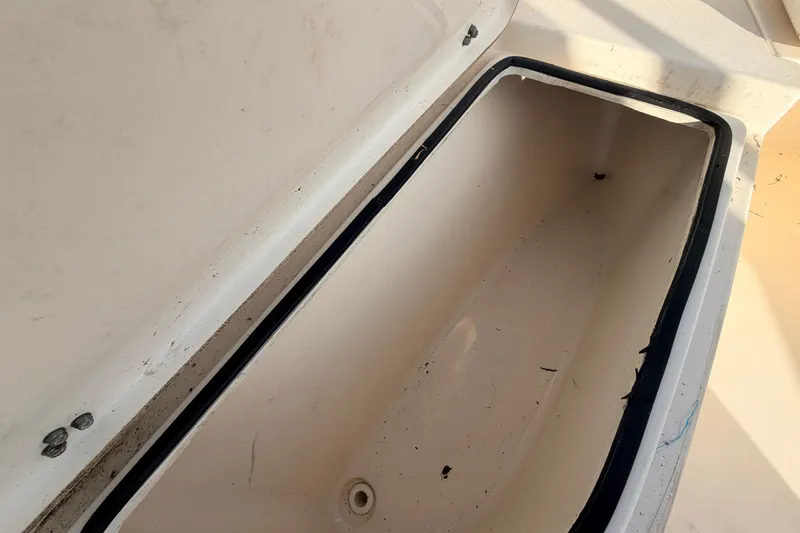 Slide: The Image of Open storage compartment on a 2020 Cobia 220 Center Console boat. - 33