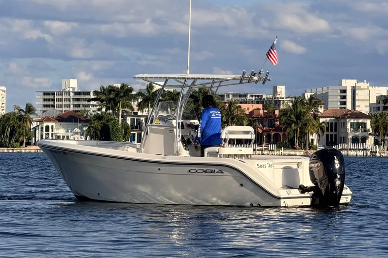 Slide: The Image of 2020 Cobia 220 Center Console boat on calm water. - 5
