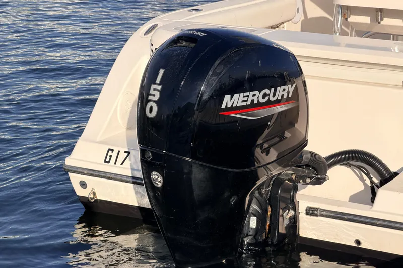 Slide: The Image of 2020 Cobia 220 Center Console with Mercury 150 outboard engine on water. - 6