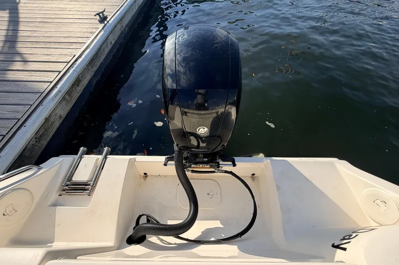 Slide: The Image of 2020 Cobia 220 Center Console boat with outboard motor at dockside. - 7