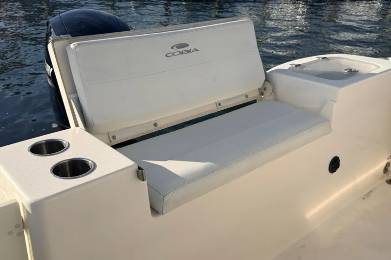 Slide: The Image of 2020 Cobia 220 Center Console boat with cushioned seating and cup holders. - 9