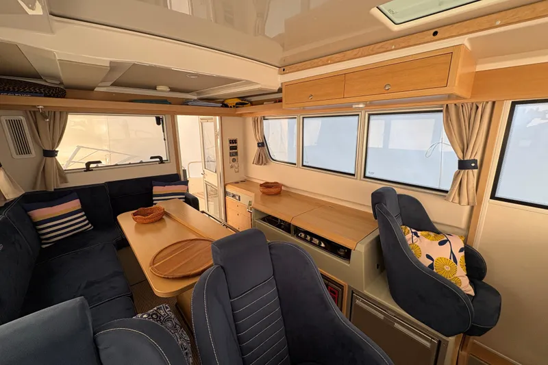 Slide: The Image of Interior of a 2021 Sargo 36 boat with cozy seating and wooden accents. - 10