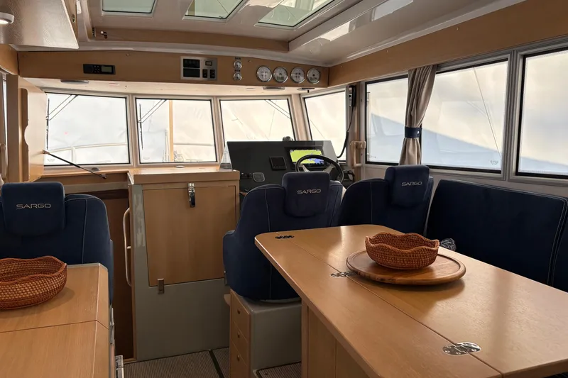 Slide: The Image of Interior of 2021 Sargo 36 boat with helm, seating, and dining area. - 12