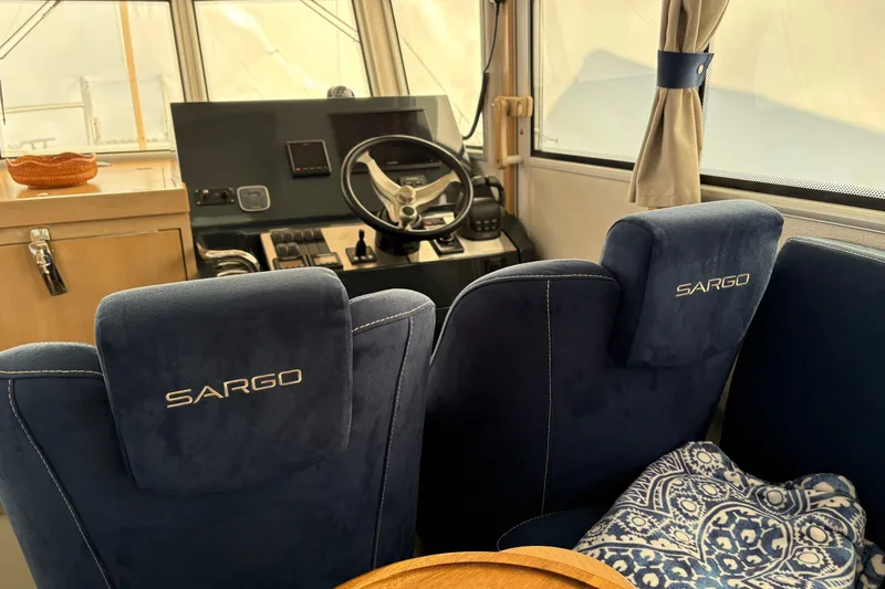 Slide: The Image of Interior of 2021 Sargo 36 boat with blue seats and steering console. - 14
