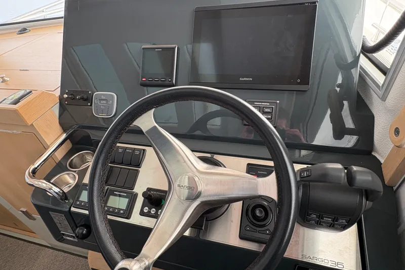 Slide: The Image of Helm of 2021 Sargo 36 boat with steering wheel and navigation controls. - 15
