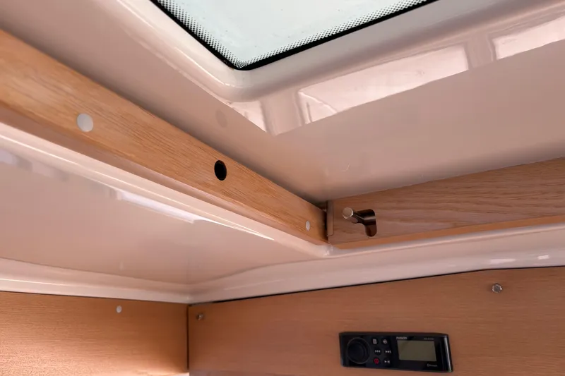 Slide: The Image of Interior detail of a 2021 Sargo 36 boat, featuring wood trim and control panel. - 20