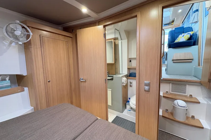 Slide: The Image of Interior of 2021 Sargo 36 boat featuring cozy cabin, bathroom, and seating area. - 22