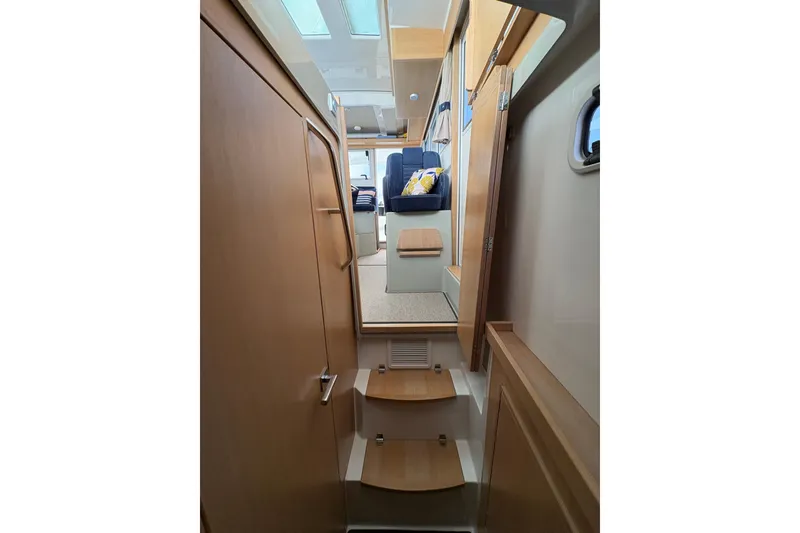 Slide: The Image of Interior of 2021 Sargo 36 boat, featuring wooden stairs and seating area. - 25