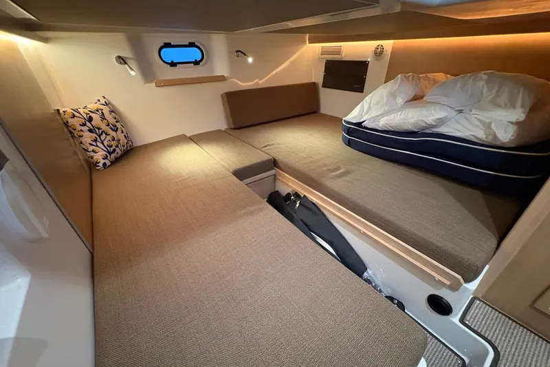 Slide: The Image of Cozy cabin interior of 2021 Sargo 36 boat with twin beds and soft lighting. - 26