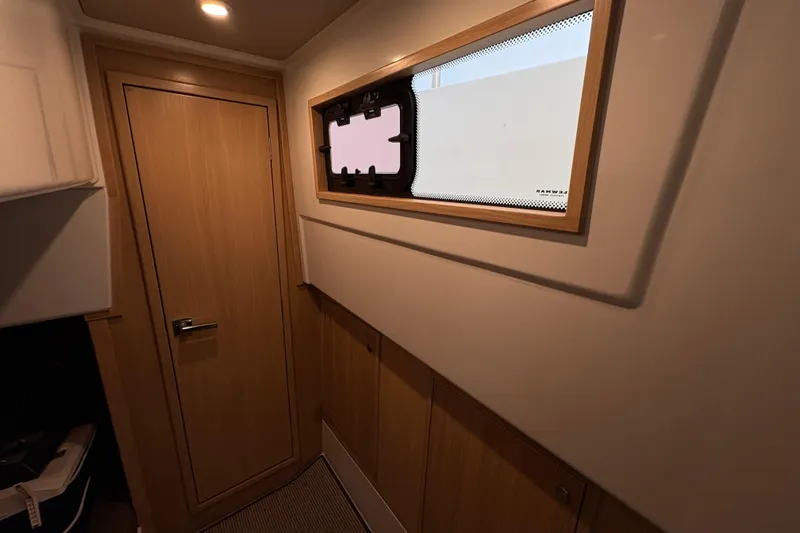 Slide: The Image of Interior of 2021 Sargo 36 boat with wooden door and window. - 28