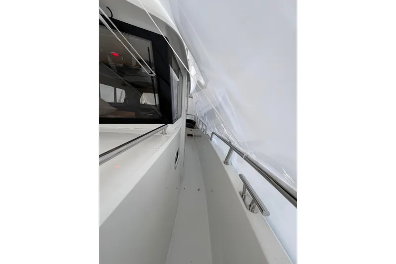 Slide: The Image of Side view of a 2021 Sargo 36 boat, showcasing sleek design and railing details. - 32